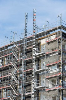 Symbolic image, residential construction, new building, corner building with extensive scaffolding,