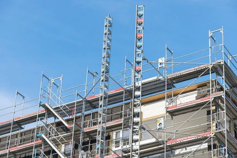 Symbolic image, residential construction, new building, corner building with extensive scaffolding,