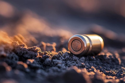 Close up of ammunition casing on ground. Spent bullet shell detail in outdoor setting. Generative