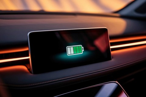 Electric car dashboard showing half full battery charge in close-up display. Generative Ai, AI