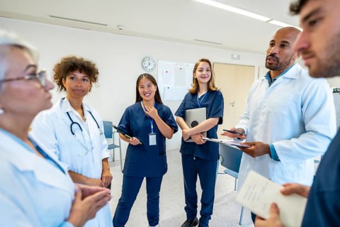Doctors and nurses engaging in a collaborative discussion during a meeting at the hospital, sharing