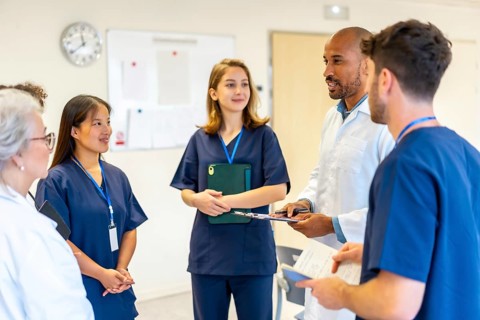 Diverse medical professionals collaborating, sharing expertise, and reviewing patient information