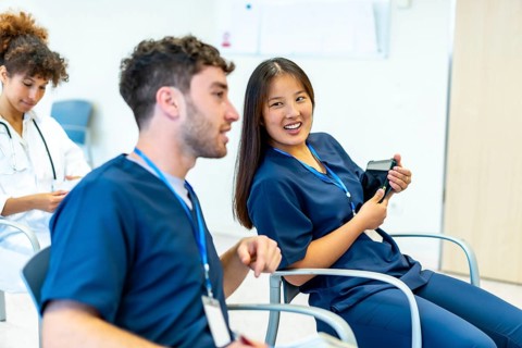 Group of medical professionals attending a conference, actively engaging in discussion and learning