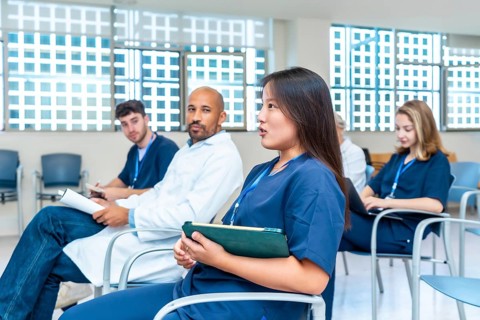 Diverse group of healthcare professionals participating in a medical conference, actively engaging
