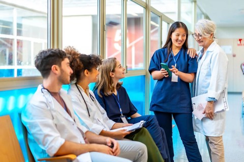 Doctors and nurses reviewing medical records on a smartphone, fostering collaboration and