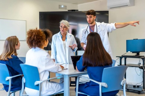 Doctors and nurses having a meeting in a hospital conference room, discussing patient cases and