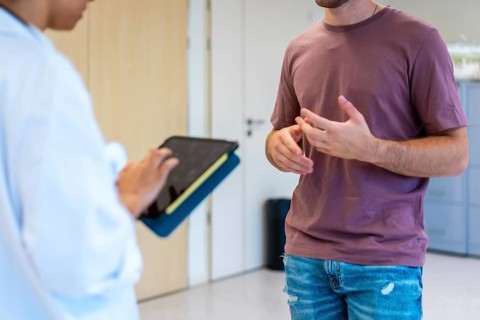 Medical professional using digital tablet while consulting with patient, enhancing healthcare