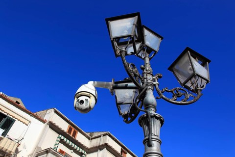 Surveillance camera on a lamppost in a public space