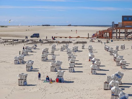 Preparing for the high season on the beach, first guests on the beach, setting up the beach chairs,