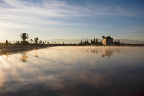The Menara gardens, basin and minzah, a palace-like pavilion, High Atlas mountains behind, Morocco