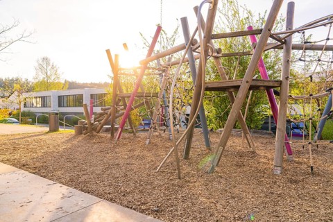 Sunlit playground with wooden climbing structures, Christiane Herzog Realschule, Nagold, district
