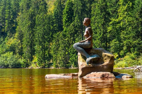 Beautiful landscape with the mermaid sculpture in summer at Mummel Lake or mummelsee, Black Forest,