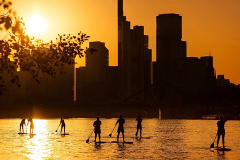 The sun sets behind the Frankfurt banking skyline, Frankfurt am Main, Hesse, Germany