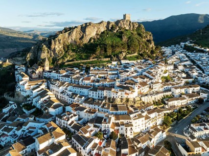 The White Town of Zahara de la Sierra below a Moorish castle. Aerial view. Drone shot. Cádiz