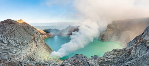Volcano Kawah Ijen, volcanic craters with crater lake and steaming vents, morning light,
