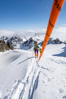 Ski tourer with rope, rope team on the Vadret da Porchabella glacier on the ascent to the summit of
