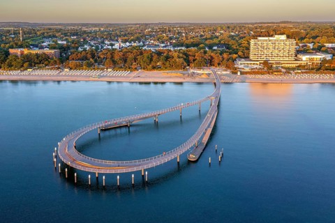 Aerial view over Maritim Seebrücke / maritime pier over the Baltic Sea at seaside resort