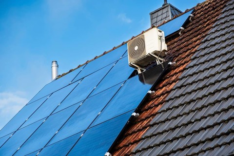Solar panels and air conditioning on the roof of a detached house in Essen, Germany