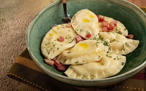 Dumplings, with fried prosciutto, a traditional dish of Polish cuisine, dumplings, top view,