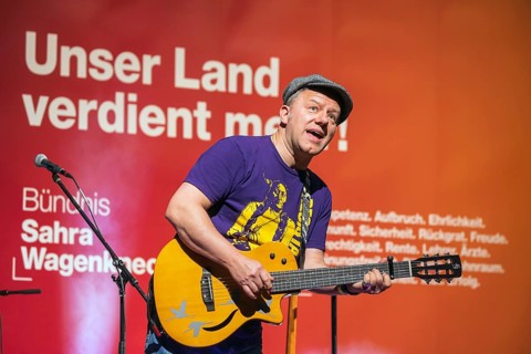 Tino Eisbrenner plays music on stage. Election event of the party Bündnis Sahra Wagenknecht for the