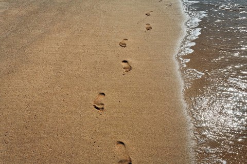 Footprint in the sand, on the shore, Simos beach, evening light, text free space, symbol photo,