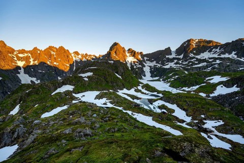 Rocky mountain peaks with snow, at the Trollfjord Hytta, mountain landscape with alpenglow at