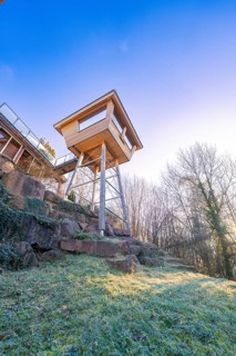 Modern tree house with large windows on a natural cliff, Hotel Krone Lamm, Zavelstein, Black