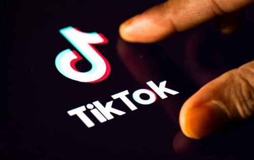 In this photo Illustration a person browsing taps Tiktok Application on a tablet device on 24 May
