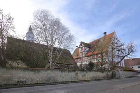 Historic office building built in 1610 with the tower of St Martin's Church, Langenau, Alb-Donau
