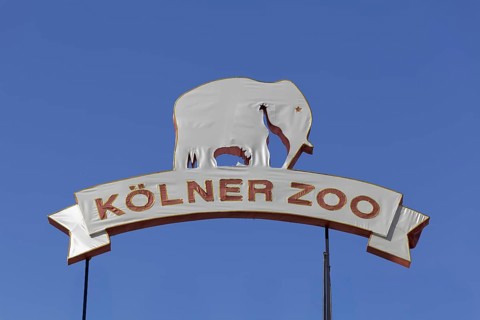 Cologne Zoo 165 years, anniversary sign covered with fabric in front of a blue sky, Cologne, North