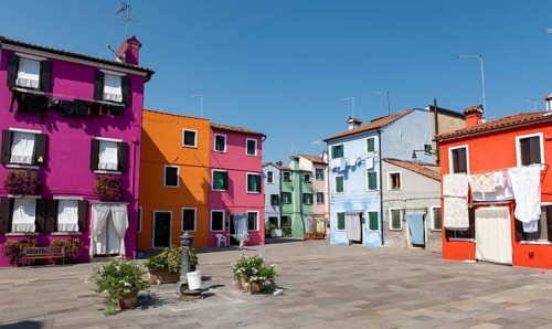 Colourful houses with washing lines and flowers, colourful house facades, alleyways on the island