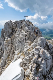 Mountain peak Ackerlspitze with summit cross, mountaineer on the last ascent to the summit, Wilder