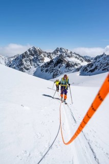 Ski tourers walking on a rope over the Vadret da Porchabella glacier, Bündner Haute Route ski tour,