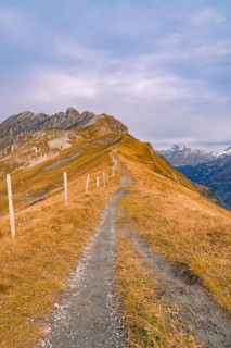 Narrow hiking trail on a remote mountain ridge, Planplatten, Switzerland