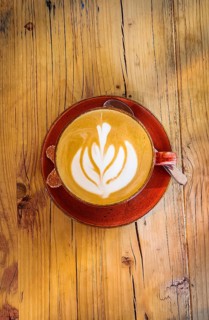 Cappuccino with floral pattern in milk foam, wooden table, coffee, cup, coffee mug, drink, caffeine