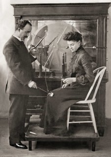 A patient being treated by Proffessor Wilhelm Conrad Röntgen with a friction spark treatment, an