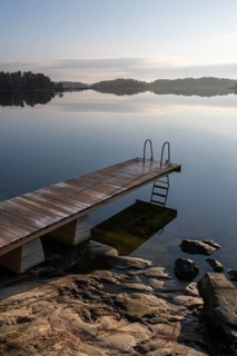 Wooden jetty with ladder, calm water surface, morning atmosphere, Kasnäsintie, Falkö Fjord, Kasnäs,