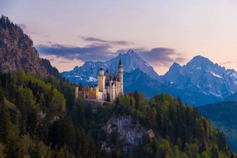 Neuschwanstein Castle romantic in front of an alpine evening mood, Schwangau near Füssen, Ostallgäu