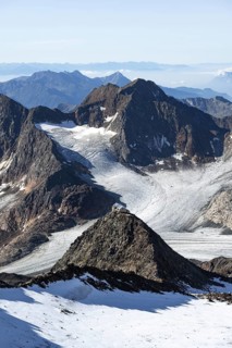 At the Wilder Freiger summit, picturesque high mountain landscape with snow, view of the