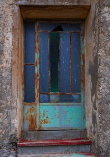 Weathered glass entrance door, mountain village of Lakkoi, Crete, Greece