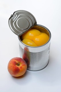 Peach, preserved peach halves with syrup in a tin can