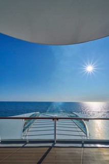 View from the ship's deck, Mein Schiff 6, of the vast sea under bright sunshine and blue skies,