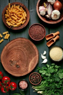 Food concept, wooden chopping board, on a wooden table, with ingredients, spices and herbs, top