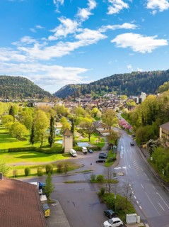 Idyllic town view with mountains, green meadows and blue sky, Bad Liebenzell, district of Calw,
