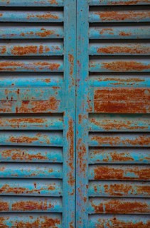 Weathered blue and red window shutter, mountain village Lakkoi, Crete, Greece
