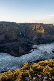 Waterfalls on a cliff, Impressive landscape with mountains and glaciers in the evening light,