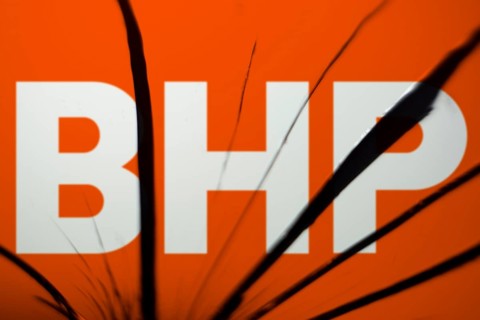BHP logo is visible on the broken glass. BHP Group Limited is an Australian multinational mining
