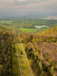 Hilly forest landscape with distant views of power lines and nature, Glems reservoir, Swabian Alb,