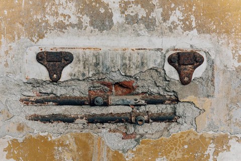 Exposed rusty water pipes, abandoned Swift factory, The Swift refrigerator in Puerto San Julián,