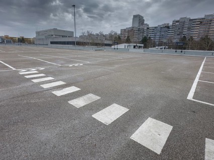 Symbolic image economic crisis, dark clouds in the sky, empty parking deck at